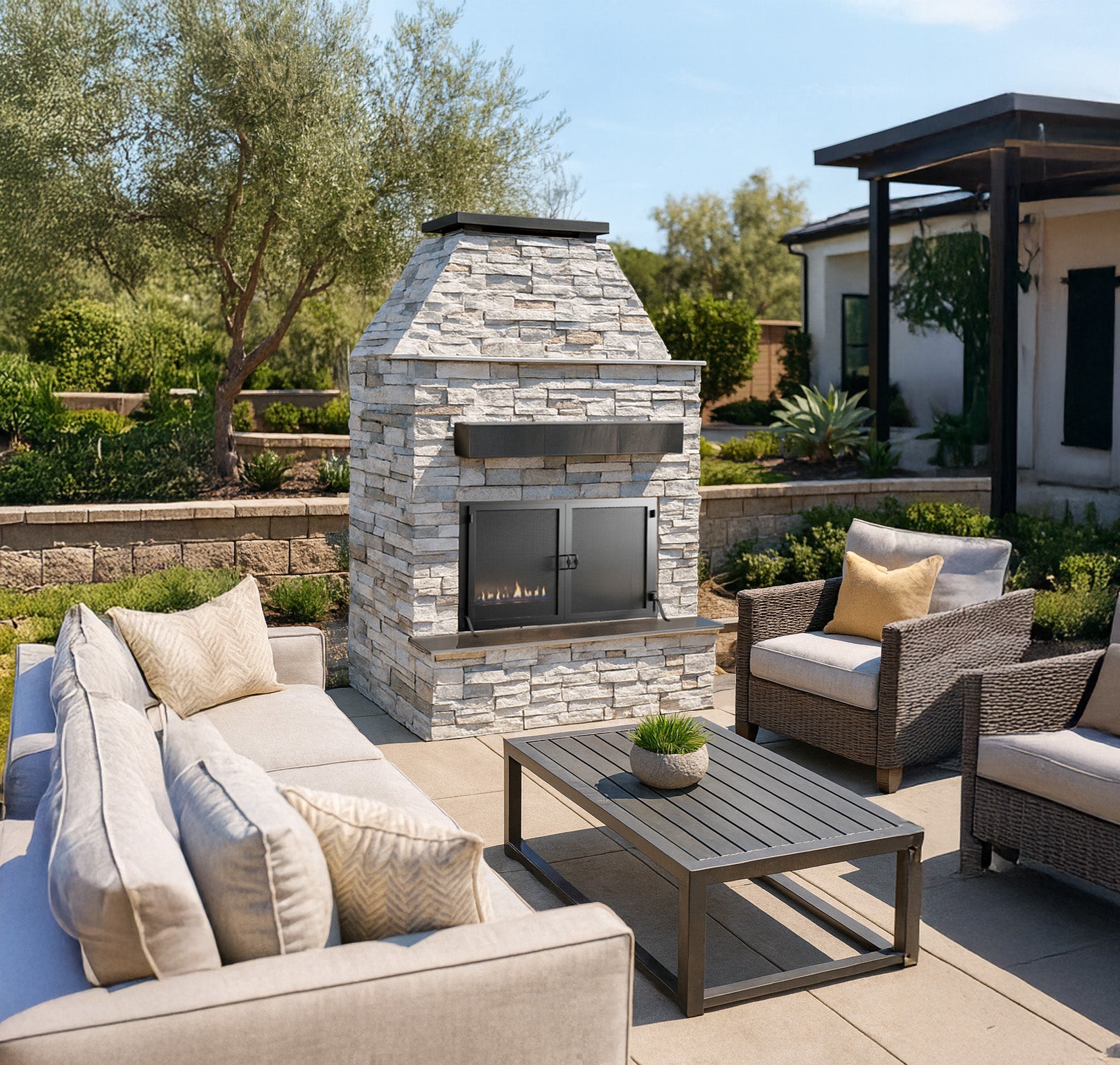 Cal Flame Durango outdoor gas fireplace with brick surround and screen door on a patio
