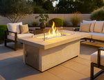 Cal Flame Phoenix 60-inch rectangle outdoor gas fire pit table with flames on a patio